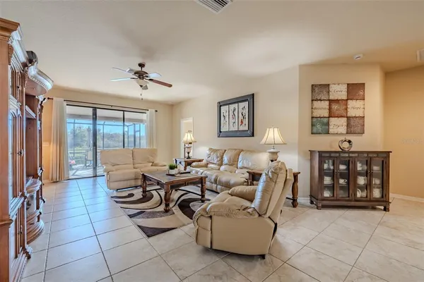 a living room with furniture a large window and flat screen tv