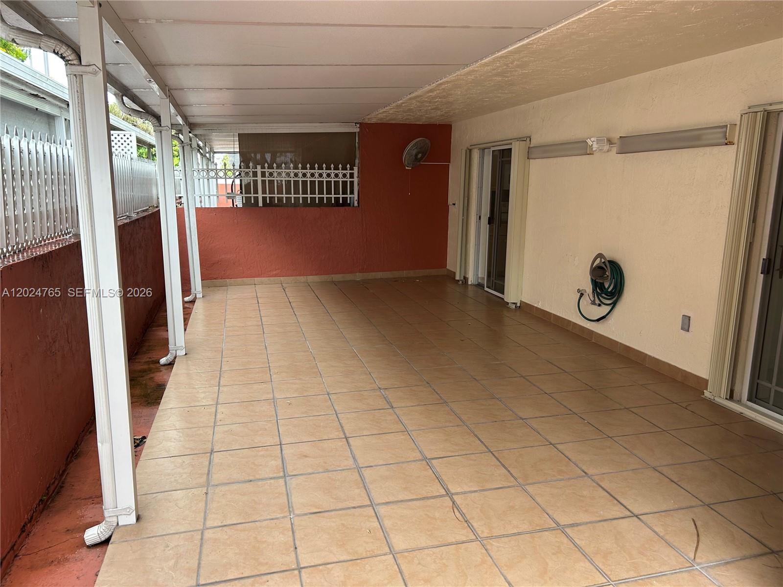 10919 West Okeechobee Road, Unit 101 Hialeah Gardens, FL 33018 - Photo 14 of 21 a view of an empty room and a window