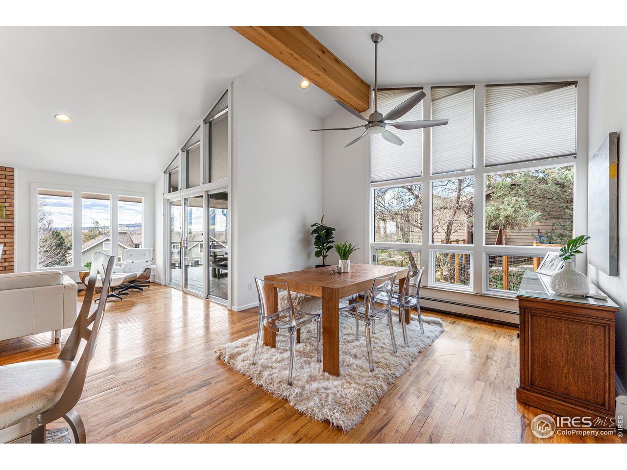 3880 Cloverleaf Drive Boulder, CO 80304 - Photo 14 of 38 a dining room with wooden floor a glass table and chairs