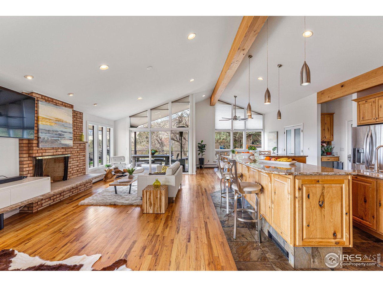 3880 Cloverleaf Drive Boulder, CO 80304 - Photo 15 of 38 a living room with lots of dining room and wooden floor
