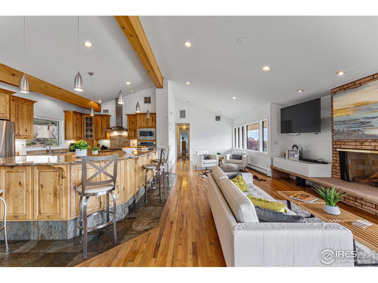3880 Cloverleaf Drive Boulder, CO 80304 - Photo 16 of 38 a view of a living room and a kitchen with stainless steel appliances