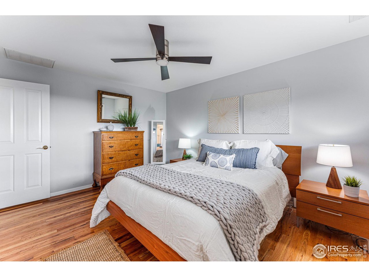 3880 Cloverleaf Drive Boulder, CO 80304 - Photo 22 of 38 a bedroom with a bed and wooden floor