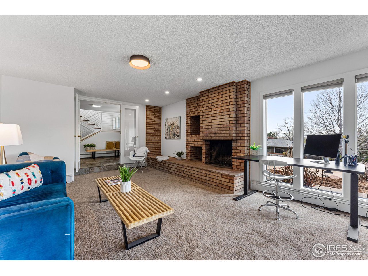 3880 Cloverleaf Drive Boulder, CO 80304 - Photo 24 of 38 a living room with furniture and a fireplace