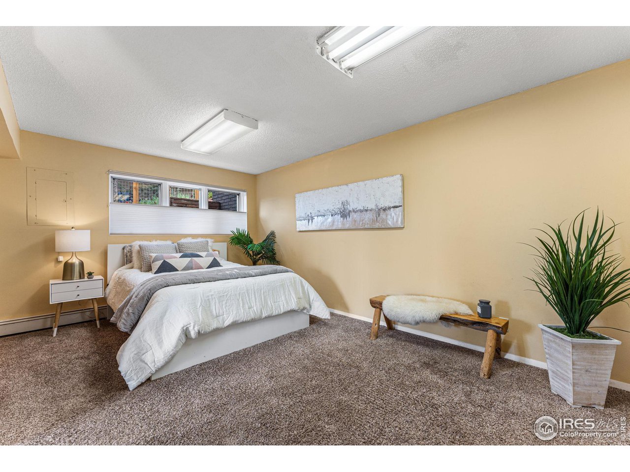 3880 Cloverleaf Drive Boulder, CO 80304 - Photo 27 of 38 a bedroom with a bed a couch and potted plant