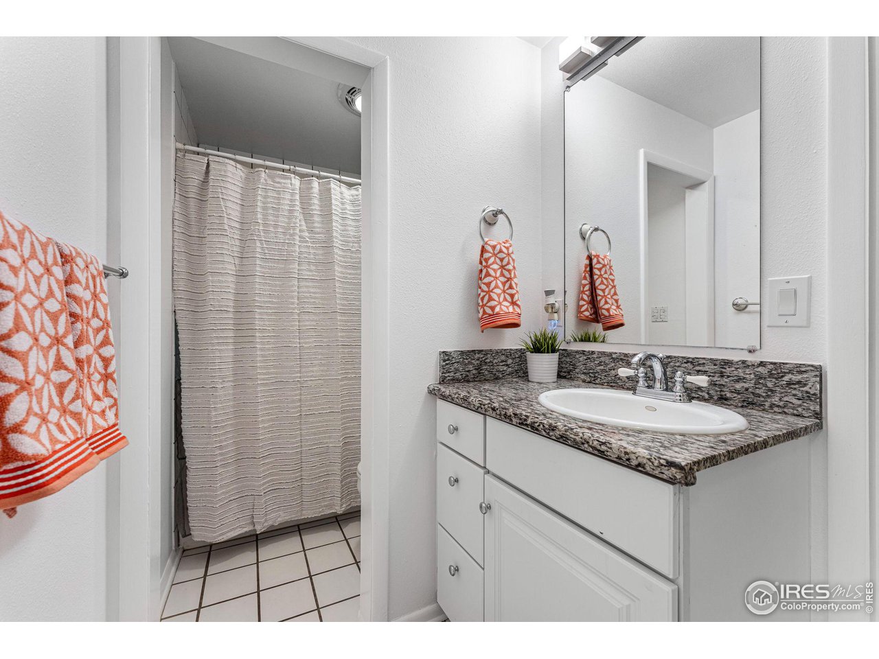 3880 Cloverleaf Drive Boulder, CO 80304 - Photo 28 of 38 a bathroom with a granite countertop sink and a mirror