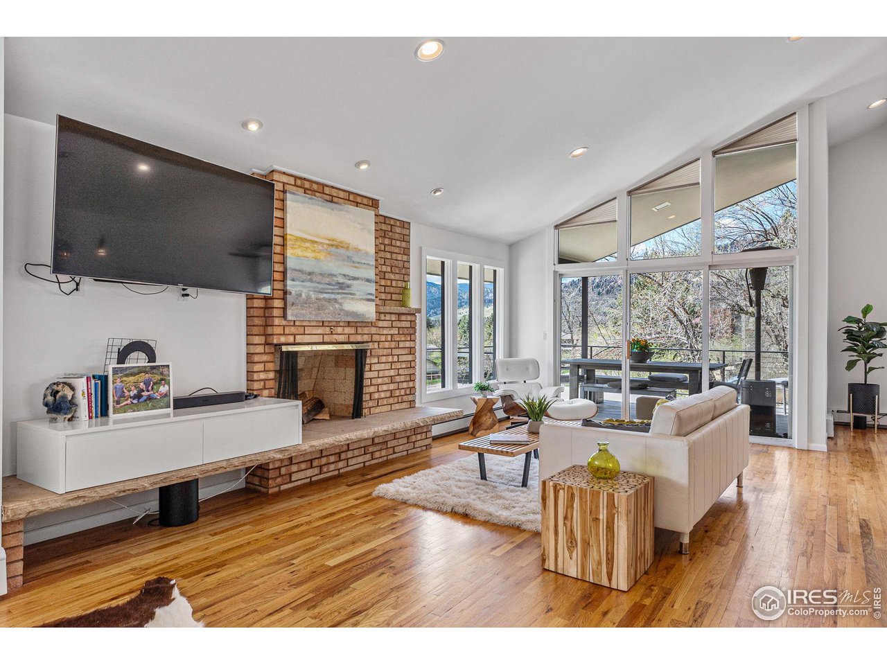 3880 Cloverleaf Drive Boulder, CO 80304 - Photo 10 of 38 a living room with furniture fireplace and flat screen tv