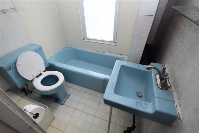 2311 Spring Street Pittsburgh, PA 15210 - Photo 24 of 24 Small bathroom--but everything you need. Note the radiant heater behind tub area.
