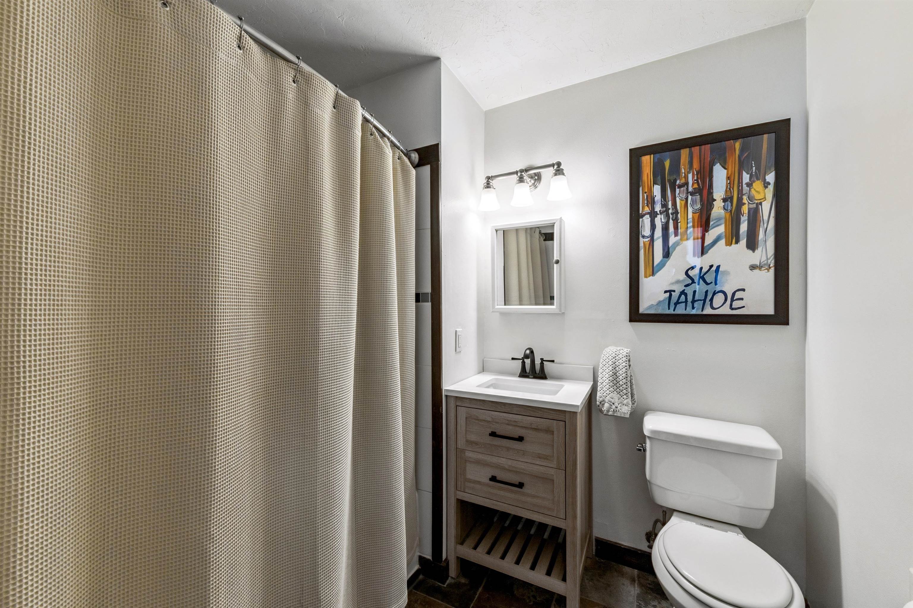 10895 Jeffery Pine Road Truckee, CA 96161 - Photo 21 of 25 a bathroom with a toilet a sink and a mirror