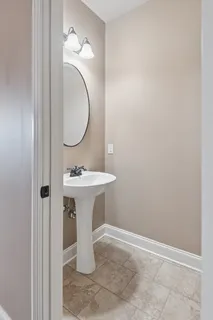 a living room with couch and a potted plant