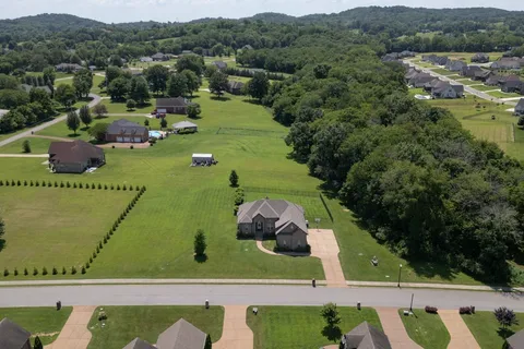 an aerial view of a house with pool