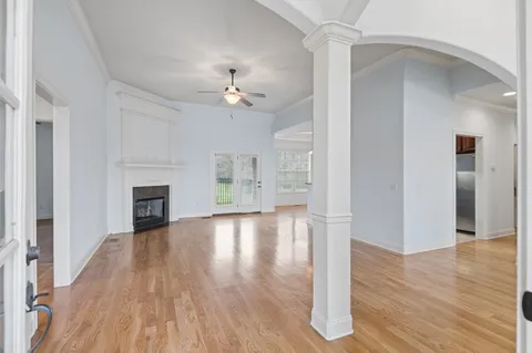 a view of empty room with wooden floor and fireplace