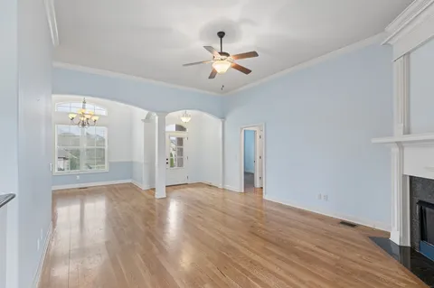 wooden floor in an empty room with a window