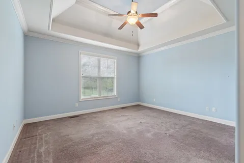 a spacious bathroom with a granite countertop sink a mirror and a bathtub
