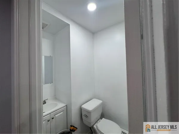 a white toilet sitting next to a bathroom sink