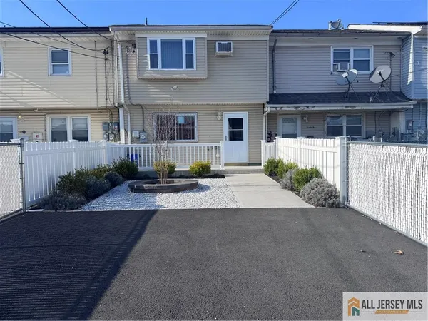 a front view of a house with a yard and a garage