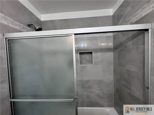 a bathroom with a shower and a sink
