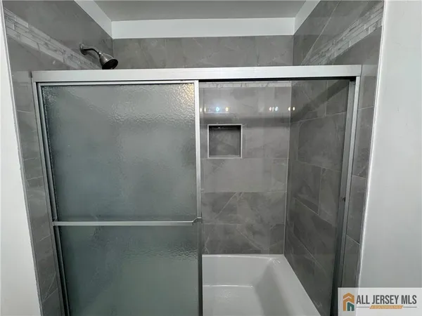 a bathroom with a glass shower door