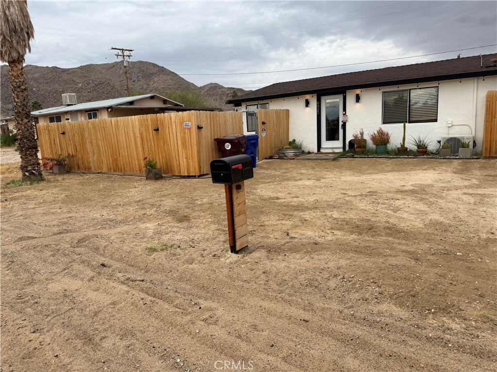6922 Datura Avenue Twentynine Palms, CA 92277 - Photo 2 of 24 a backyard of a house with barbeque oven and table