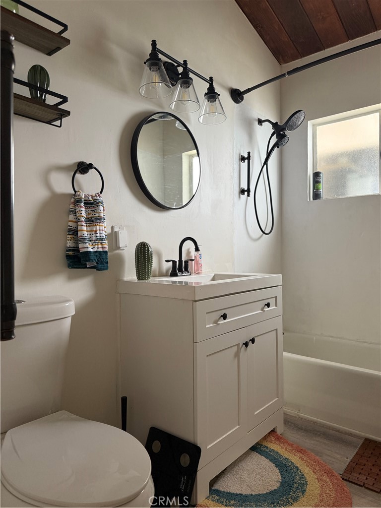 6922 Datura Avenue Twentynine Palms, CA 92277 - Photo 7 of 24 a bathroom with a toilet a sink and a mirror