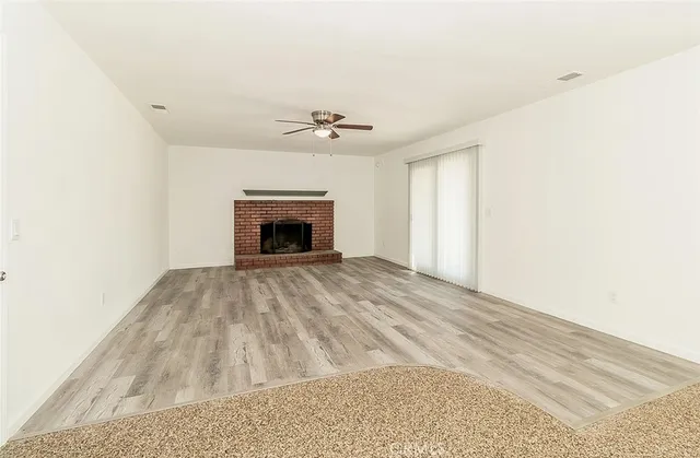 a view of empty room with a fireplace