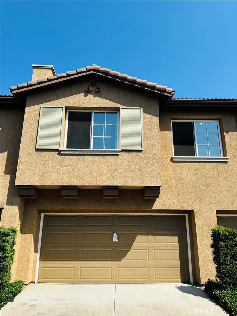 a front view of a house with garage