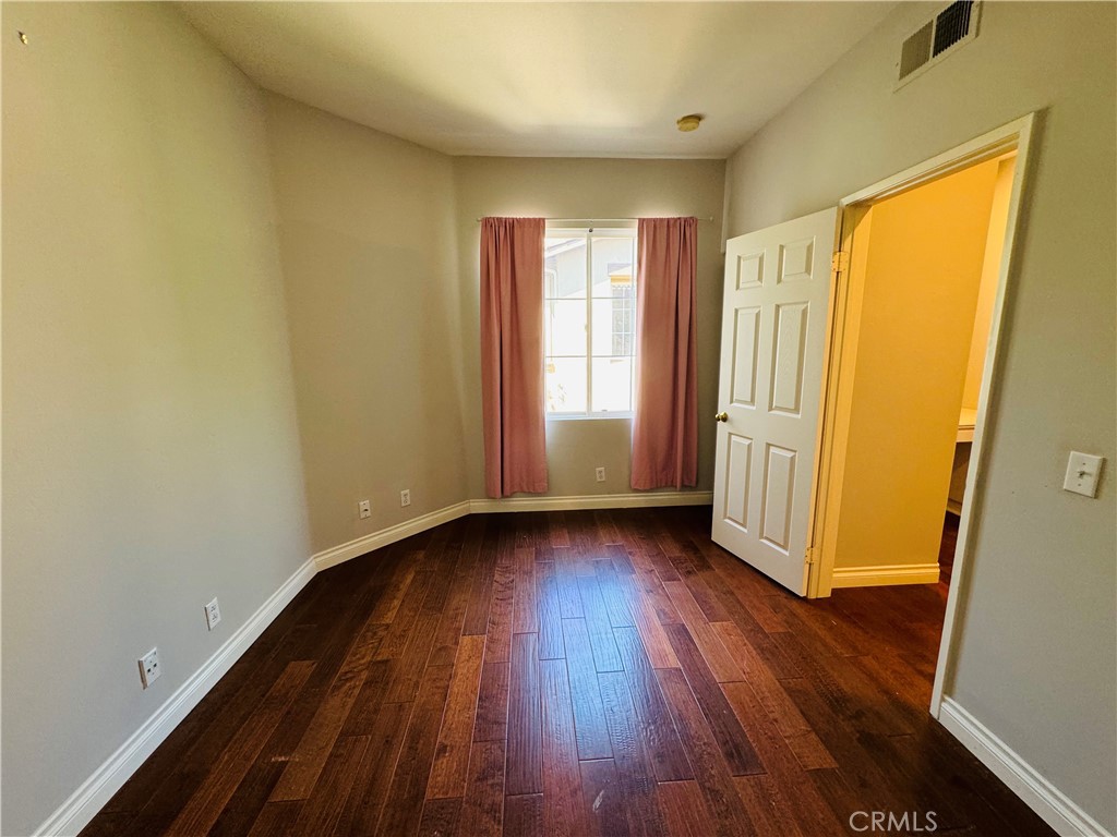 3 Bradford Irvine, CA 92602 - Photo 14 of 21 a view of an empty room with wooden floor and a window