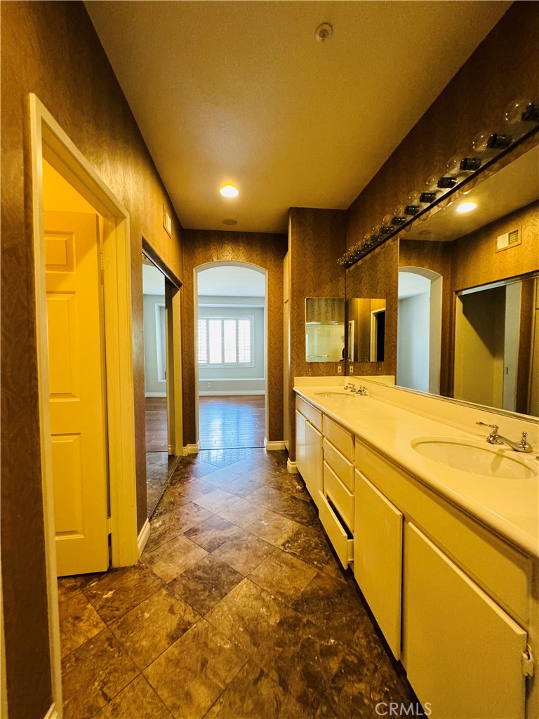 3 Bradford Irvine, CA 92602 - Photo 17 of 21 a large bathroom with a large mirror vanity and shower