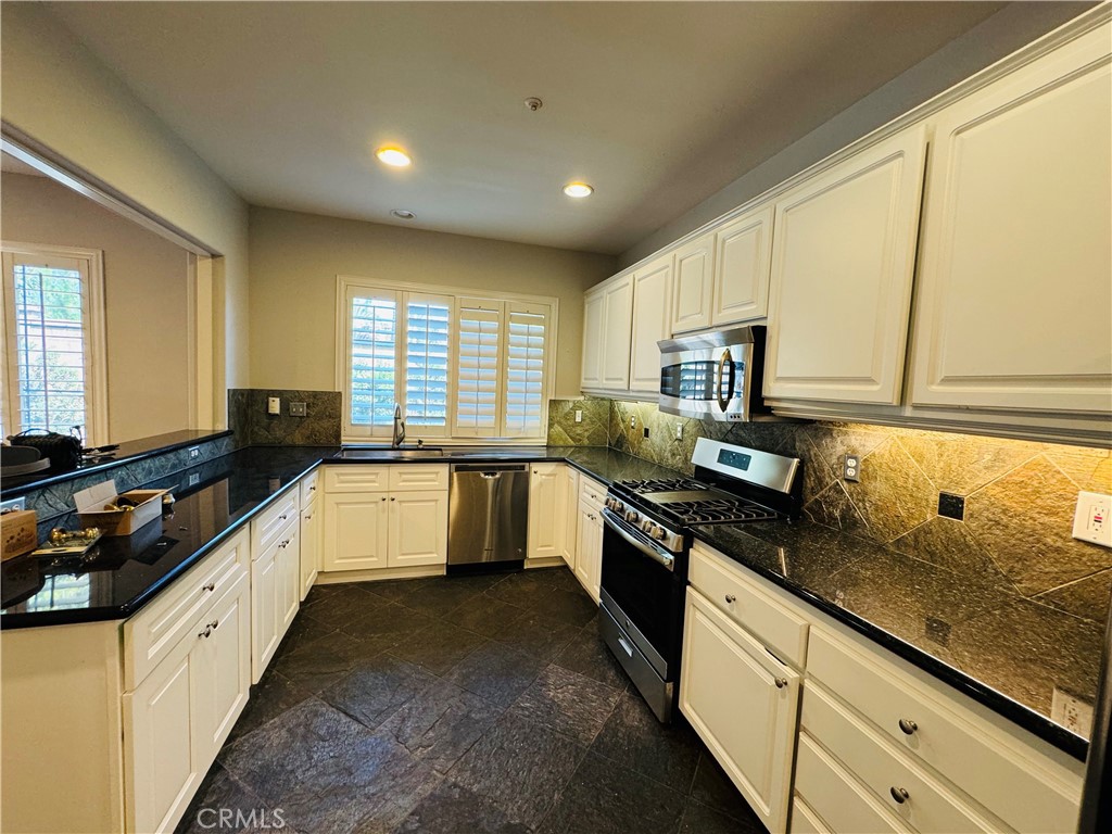 3 Bradford Irvine, CA 92602 - Photo 7 of 21 a large kitchen with granite countertop lots of counter space and sink