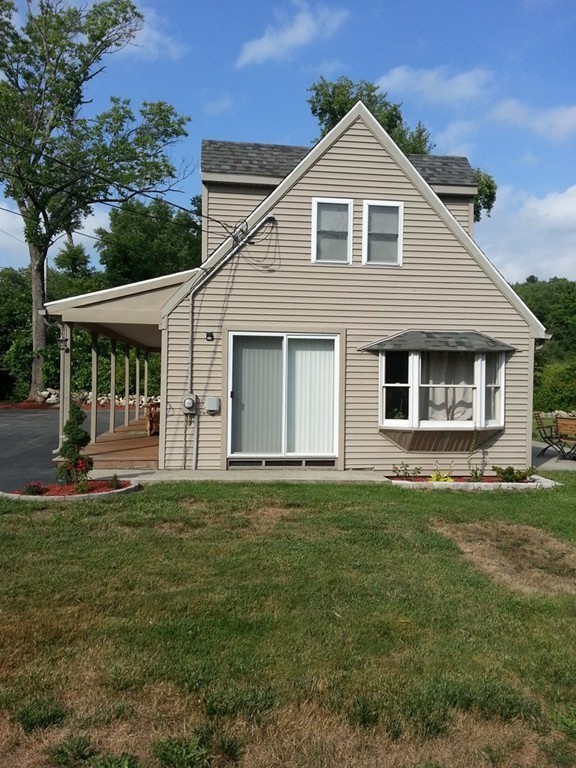 7 Doane Road Ware, MA 01082 - Photo 5 of 19 a front view of a house with a garden