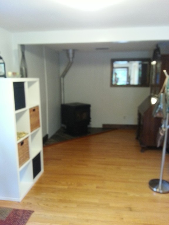 7 Doane Road Ware, MA 01082 - Photo 8 of 19 a view of an empty room with wooden floor and a window