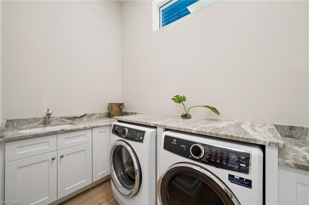 26659 Hickory Boulevard Bonita Springs, FL 34134 - Photo 19 of 46 a utility room with dryer and washer