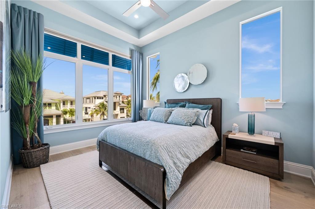 26659 Hickory Boulevard Bonita Springs, FL 34134 - Photo 25 of 46 a bedroom with a large bed and a large window