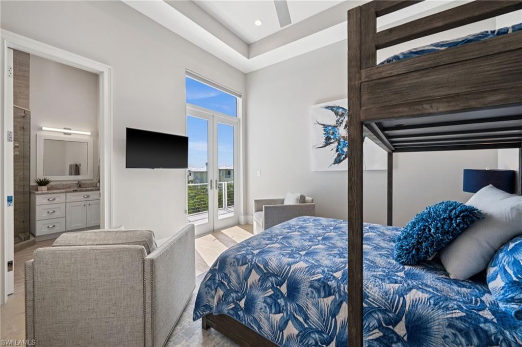 26659 Hickory Boulevard Bonita Springs, FL 34134 - Photo 36 of 46 a bedroom with a bed and a television