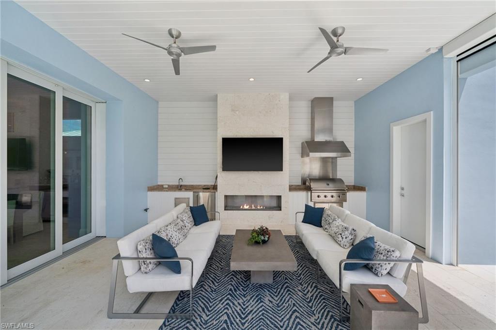 26659 Hickory Boulevard Bonita Springs, FL 34134 - Photo 40 of 46 a living room with furniture and a flat screen tv