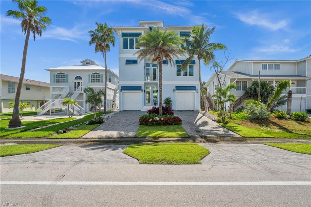 26659 Hickory Boulevard Bonita Springs, FL 34134 - Photo 5 of 46 a front view of a house with a yard and potted plants