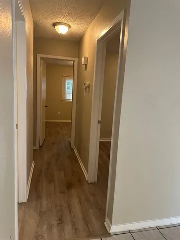 view of a hallway with wooden floor