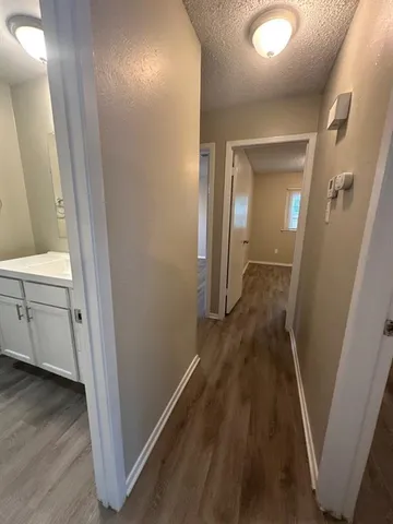 a view of a hallway and wooden floor