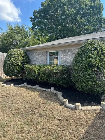 a view of a backyard with large trees