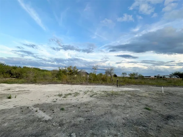 a sign board with tall trees