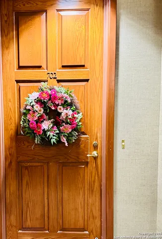 a vase of flowers sitting in front of a door
