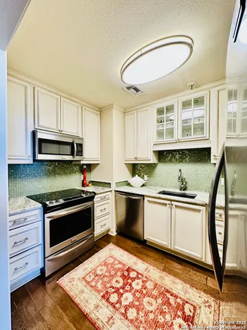 a kitchen with stainless steel appliances granite countertop a stove and a sink