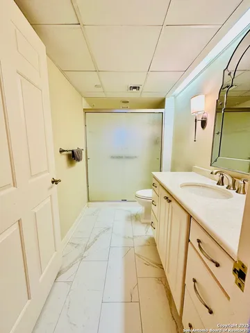 a bathroom with a sink a toilet and a mirror