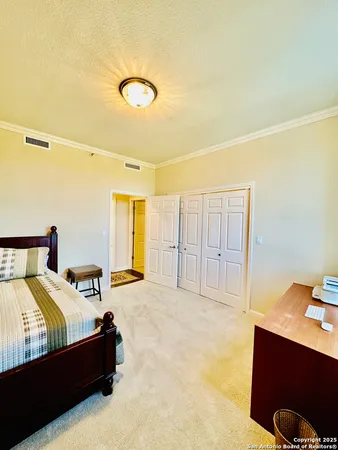 a bedroom with a bed and with furniture