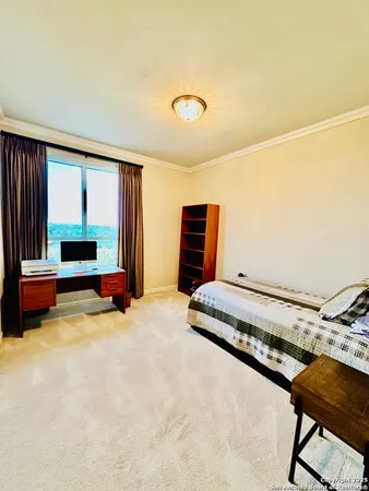 a bedroom with furniture and a window