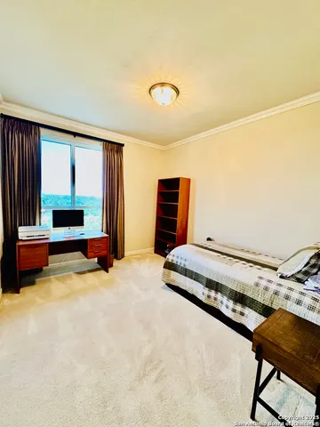 a bedroom with furniture and a window