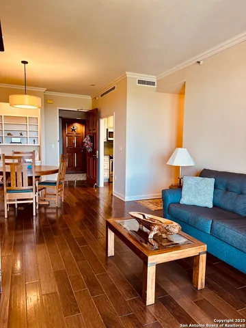 a living room with furniture and wooden floor