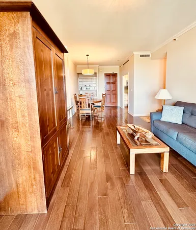 a living room with wooden floor furniture and a table
