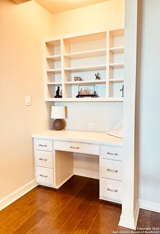 a view of cabinets and closet with wooden floor