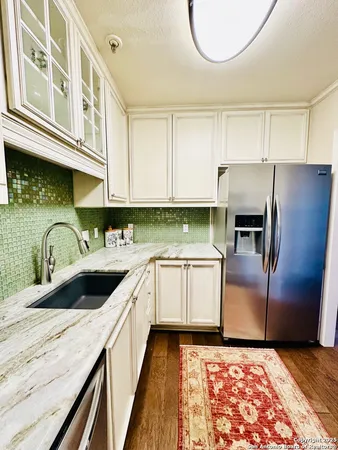 a kitchen with a sink and a refrigerator