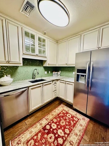 a kitchen with stainless steel appliances granite countertop a refrigerator sink and cabinets